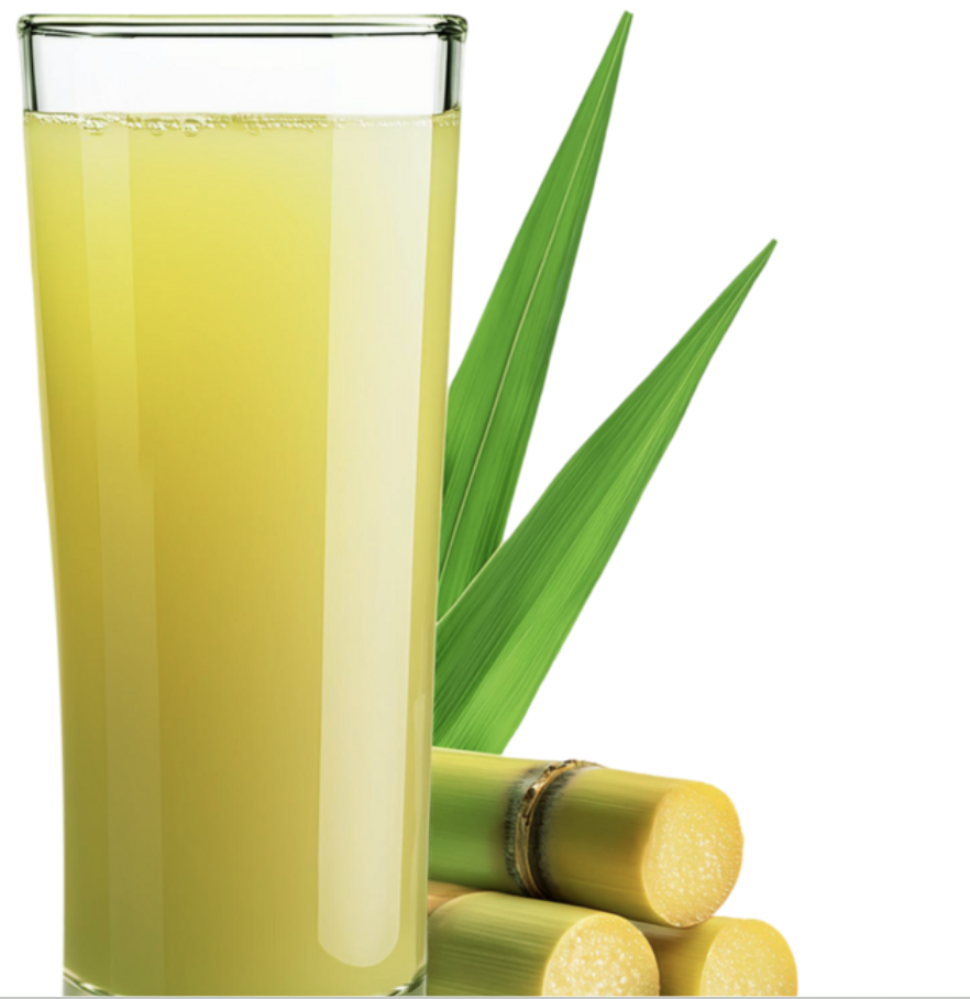 A tall glass of freshly pressed sugarcane juice beside cut cane stalks and leaves